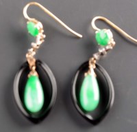 Lot 828 - A pair of jadeite earrings, the torpedo-shaped...