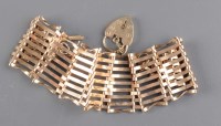 Lot 845 - A gate link bracelet, the 9ct. gold gate...