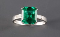 Lot 866 - An emerald and diamond ring, of emerald cut...