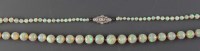 Lot 869 - An opal and diamond necklace, circa 1900, the...