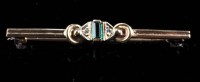 Lot 890 - An emerald and diamond brooch, the step cut...