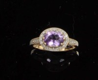 Lot 892 - An amethyst and diamond ring, the oval mixed...