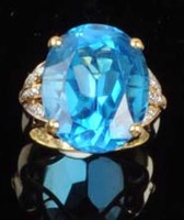 Lot 895 - A blue stone and diamond ring, the oval mixed...