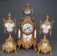 Lot 956 - A French gilt metal and porcelain three-piece...