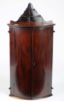 Lot 1023 - An early George III mahogany bowfront hanging...