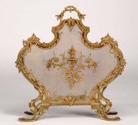 Lot 1031 - A heavy moulded brass French fireguard with...