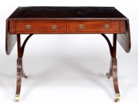 Lot 1049 - A late Georgian mahogany sofa table fitted a...