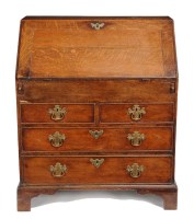 Lot 1077 - A George III oak bureau, with a rectangular...