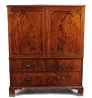 Lot 1081 - A Georgian mahogany small size linen press,...