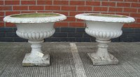 Lot 1117 - A pair of composition garden urns, painted...