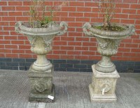 Lot 1122 - A pair of two handled composition garden urns,...