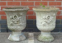 Lot 1125 - A pair of composition urns, of classical form,...