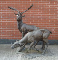 Lot 1126 - A cast metal group of a stag and a doe, late...