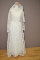 Lot 345 - A 1960's/70's cream wedding dress, tulle and...