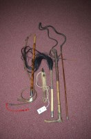 Lot 388 - Riding crops, to include: a cane, leather and...