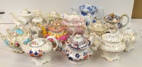 Lot 156 - Thirteen 19th Century footed teapots.