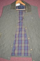 Lot 461 - A green quilted cotton waistcoat with tartan...