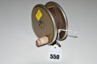 Lot 550 - A brass faced reel with nickel bound rims,...