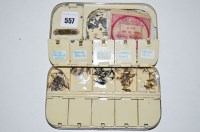 Lot 557 - A black japanned tin fly box, plaque inside...