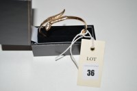 Lot 36 - A 9ct. yellow gold snake pattern bangle set...