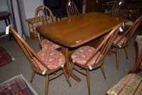 Lot 659 - An Ercol rectangular elm dining table, raised...