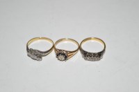 Lot 41 - A three stone diamond ring set in white metal,...