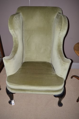 Lot 678 - A 19th Century wing back armchair, raised on...