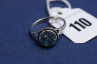 Lot 110 - A blue zircon ring, the circular facet cut...