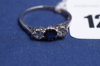 Lot 126 - A three stone sapphire and diamond ring, on...