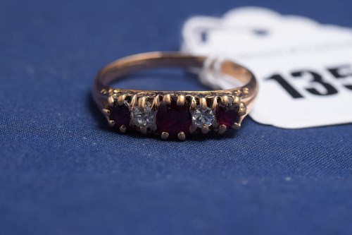 Lot 135 - A five stone ruby and diamond ring on yellow...