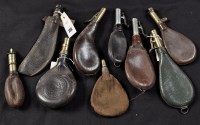 Lot 356 - Eight leather bagged shot and powder flasks,...