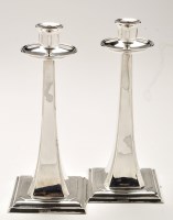 Lot 708 - A pair of George V silver candlesticks, by...