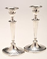 Lot 722 - A pair of Edwardian silver candlesticks, by...