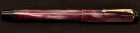 Lot 805 - A Conway Stewart roller ball pen, in purple...