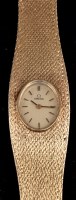 Lot 818 - Omega: a lady's 9ct. gold wristwatch, the oval...