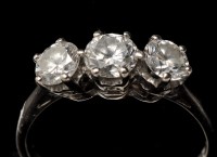 Lot 858 - A three stone diamond ring, the three...