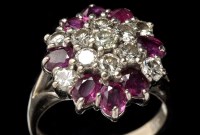 Lot 859 - A ruby and diamond dress ring, the eight oval...