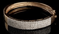 Lot 863 - A diamond bangle, the face set with five rows...