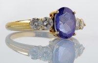 Lot 867 - A tanzanite and diamond ring, the oval facet...