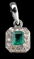 Lot 870 - An emerald and diamond drop pendant, the...