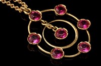 Lot 870A - A Burmese ruby drop pendant, the central ruby...