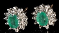 Lot 873 - A pair of emerald and diamond cluster stud...