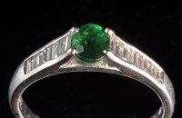 Lot 877 - A tsavorite garnet and diamond ring, the oval...