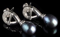 Lot 878 - A pair of cultured black pearl and diamond...