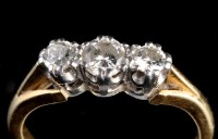 Lot 881 - A three stone diamond ring, the graduated...