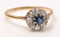 Lot 889 - A sapphire and diamond cluster ring, the...