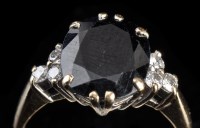 Lot 891 - A sapphire and diamond ring, the oval facet...