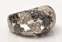 Lot 897 - A black and colourless diamond ring, in heart...