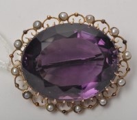 Lot 927 - An amethyst and seed pearl brooch, the oval...