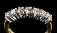 Lot 930 - A seven stone diamond ring, the brilliant cut...